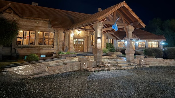 A large, rustic building with a prominent porch and multiple windows. - Villa De Merlo Hotel Spa (Merlo)