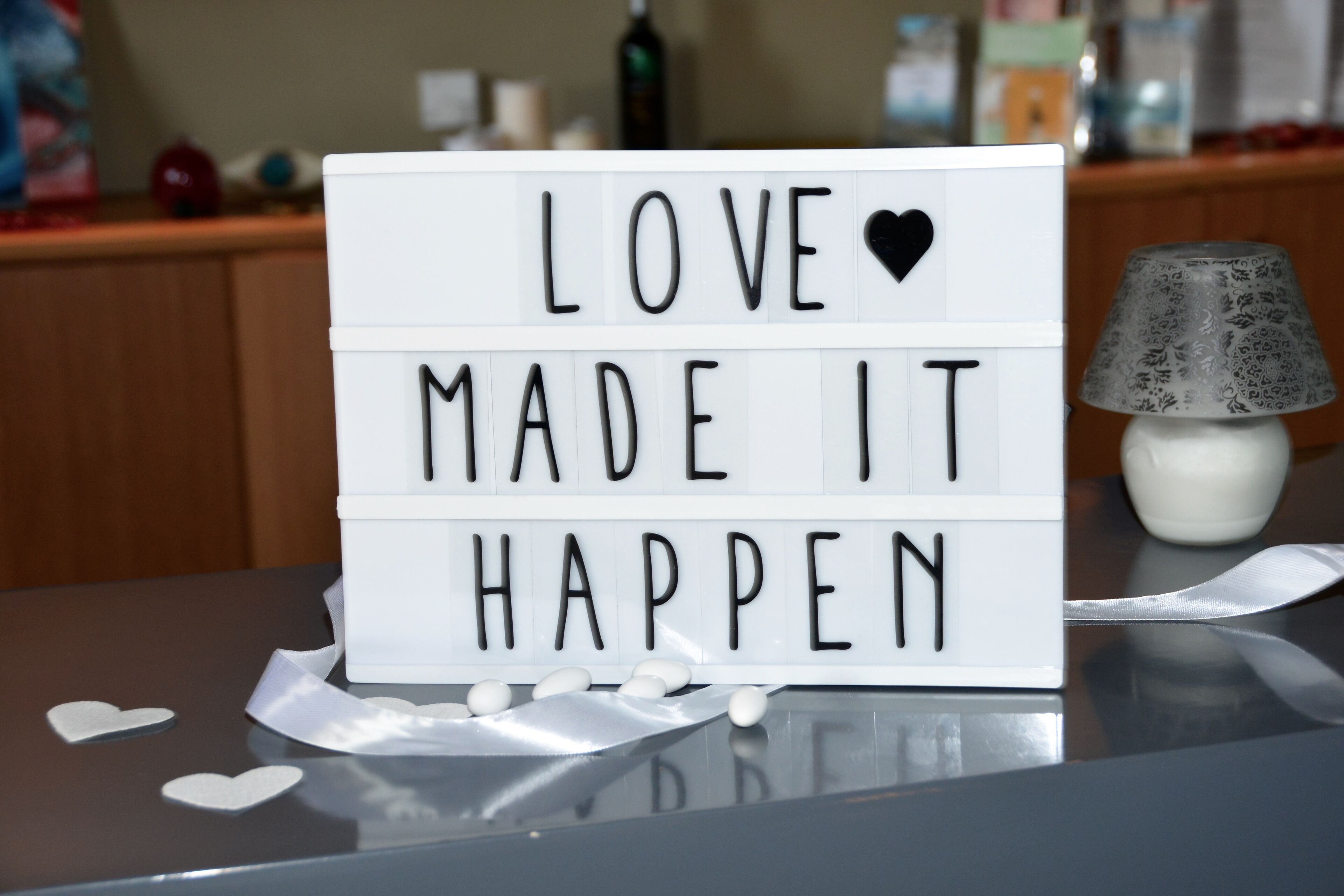 A lightbox with the message "LOVE MADE IT HAPPEN" and decorative hearts.
