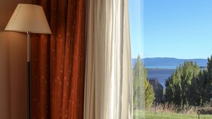 Enjoy breathtaking views of the water and distant mountains from this serene room.