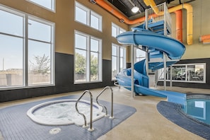 An indoor water park with a hot tub, a water slide, and a pool. - Best Western Blairmore (Saskatoon)
