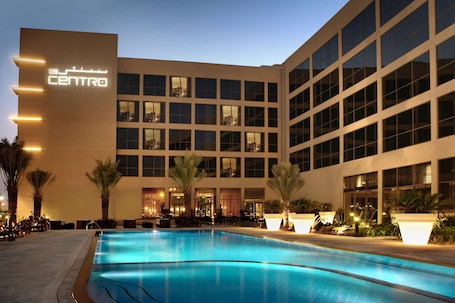 Outdoor pool, open 7:00 AM to 9:00 PM, pool umbrellas, pool loungers. Centro Sharjah by Rotana