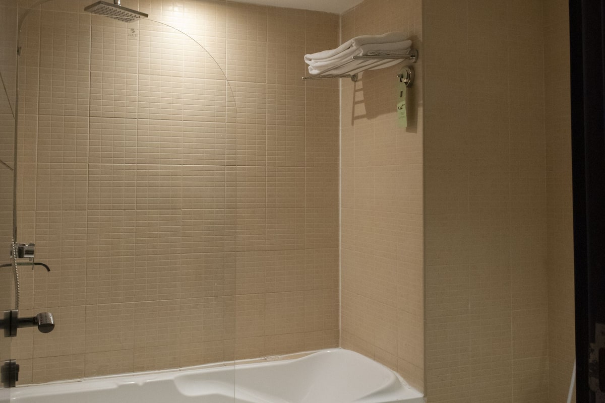 separate bathtub and shower, rainfall showerhead, designer toiletries