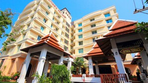 A multi-story hotel with a traditional architectural style, featuring balconies and a central courtyard. - Aiyara Palace (Pattaya)