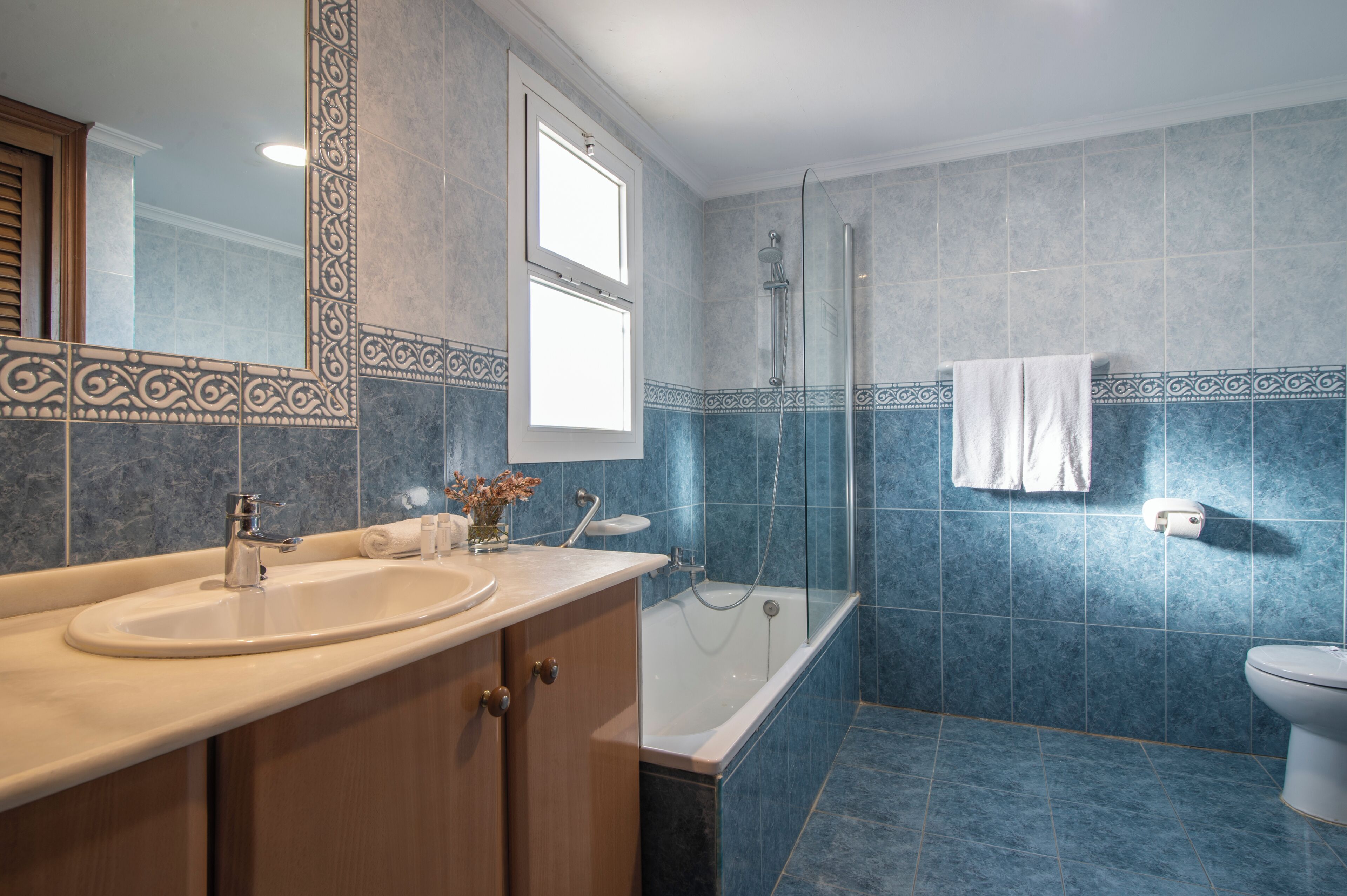 A bathroom with a bathtub, a sink, and a toilet.