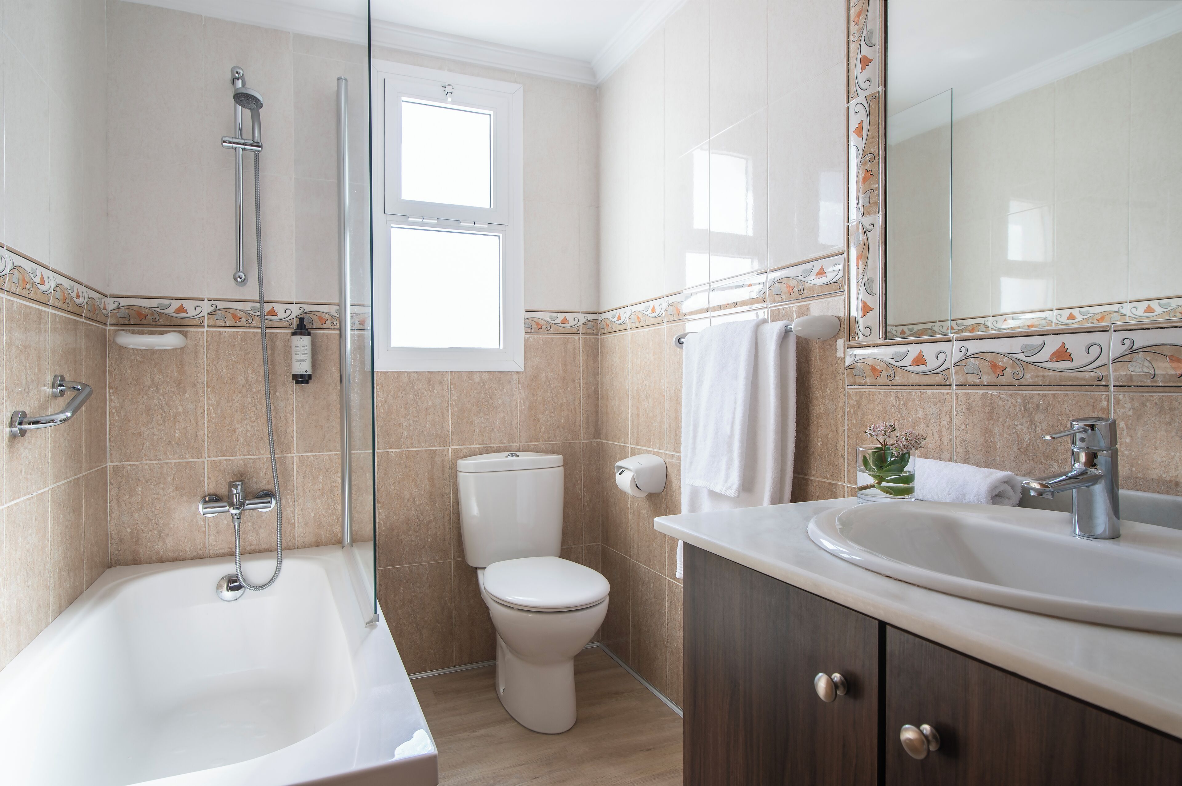 A modern bathroom with a bathtub, toilet, and sink.