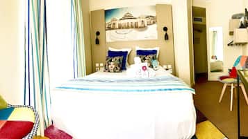 Relax in comfort with a large bed, framed artwork, and a convenient table for your essentials.