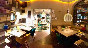 Enjoy meals in this stylish dining area with a long table and comfortable seating.