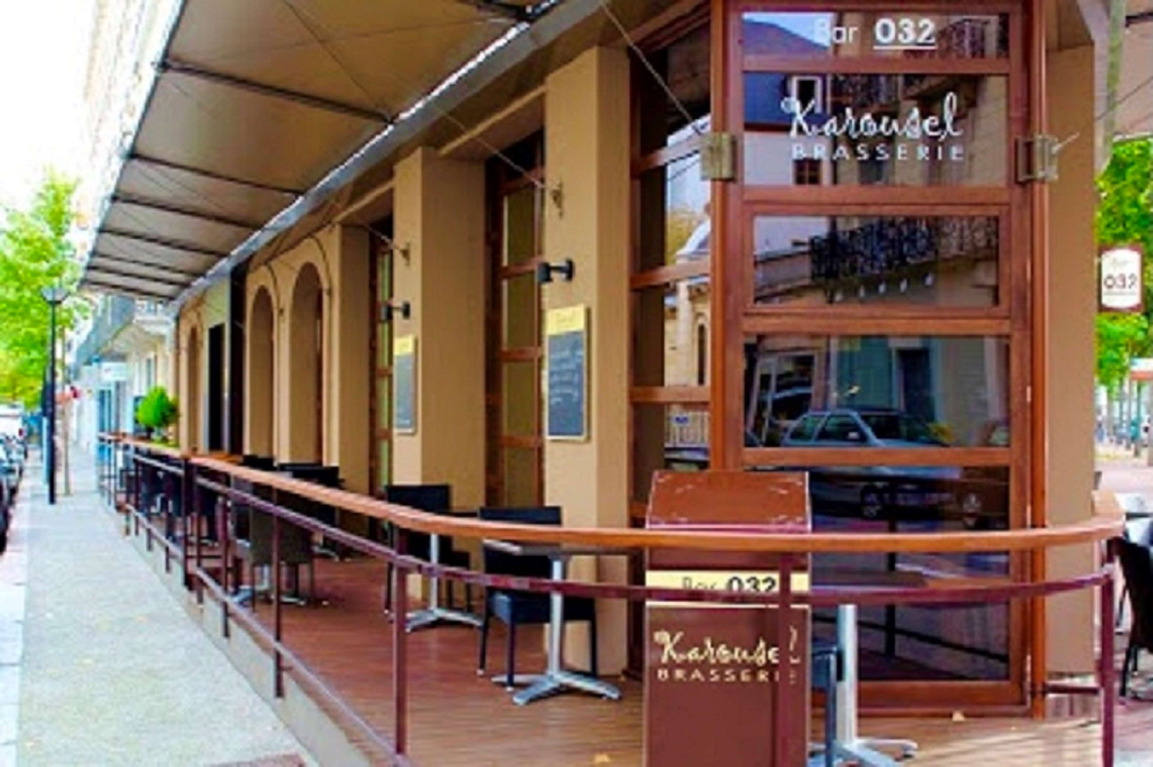 A restaurant named Karousel Brasserie with outdoor seating and a covered patio area.