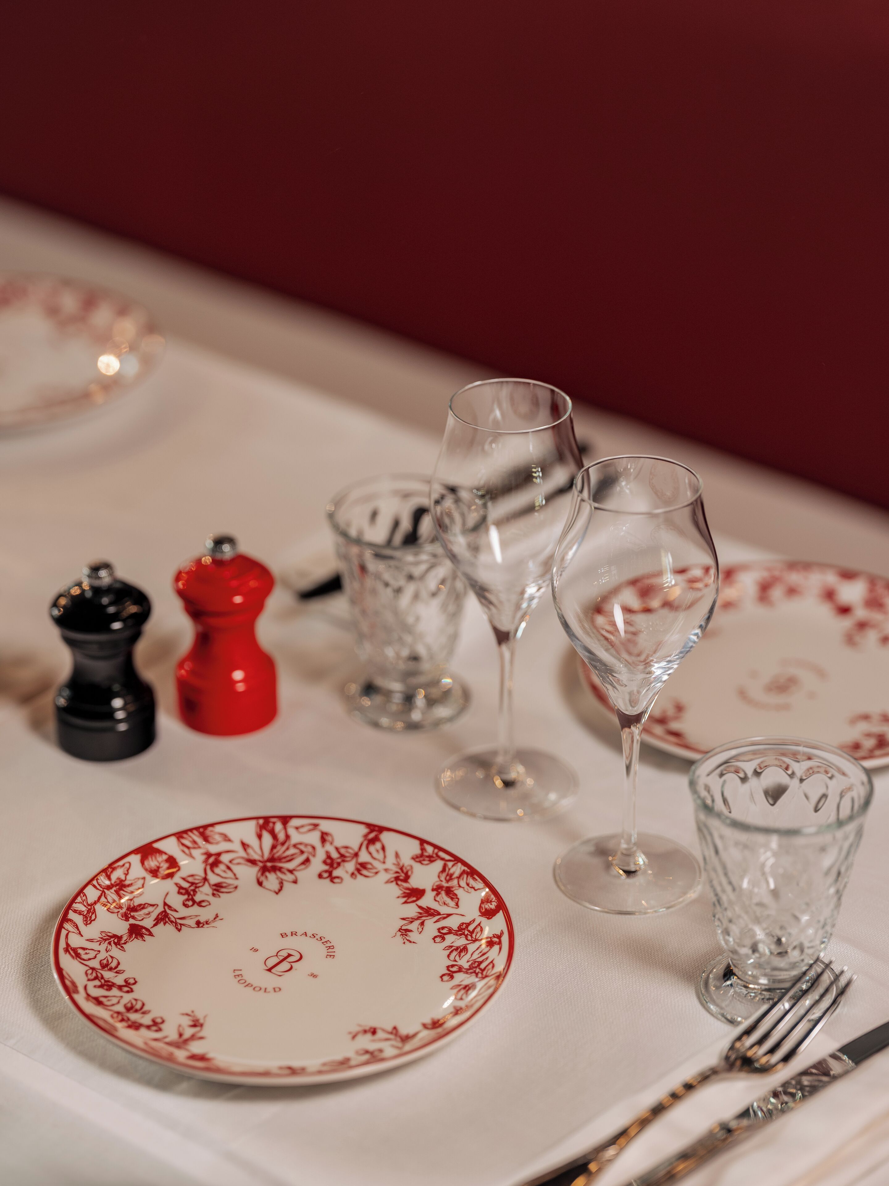 A table set with plates, glasses, and cutlery.