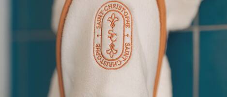 A white bathrobe with a logo and text on the inside.