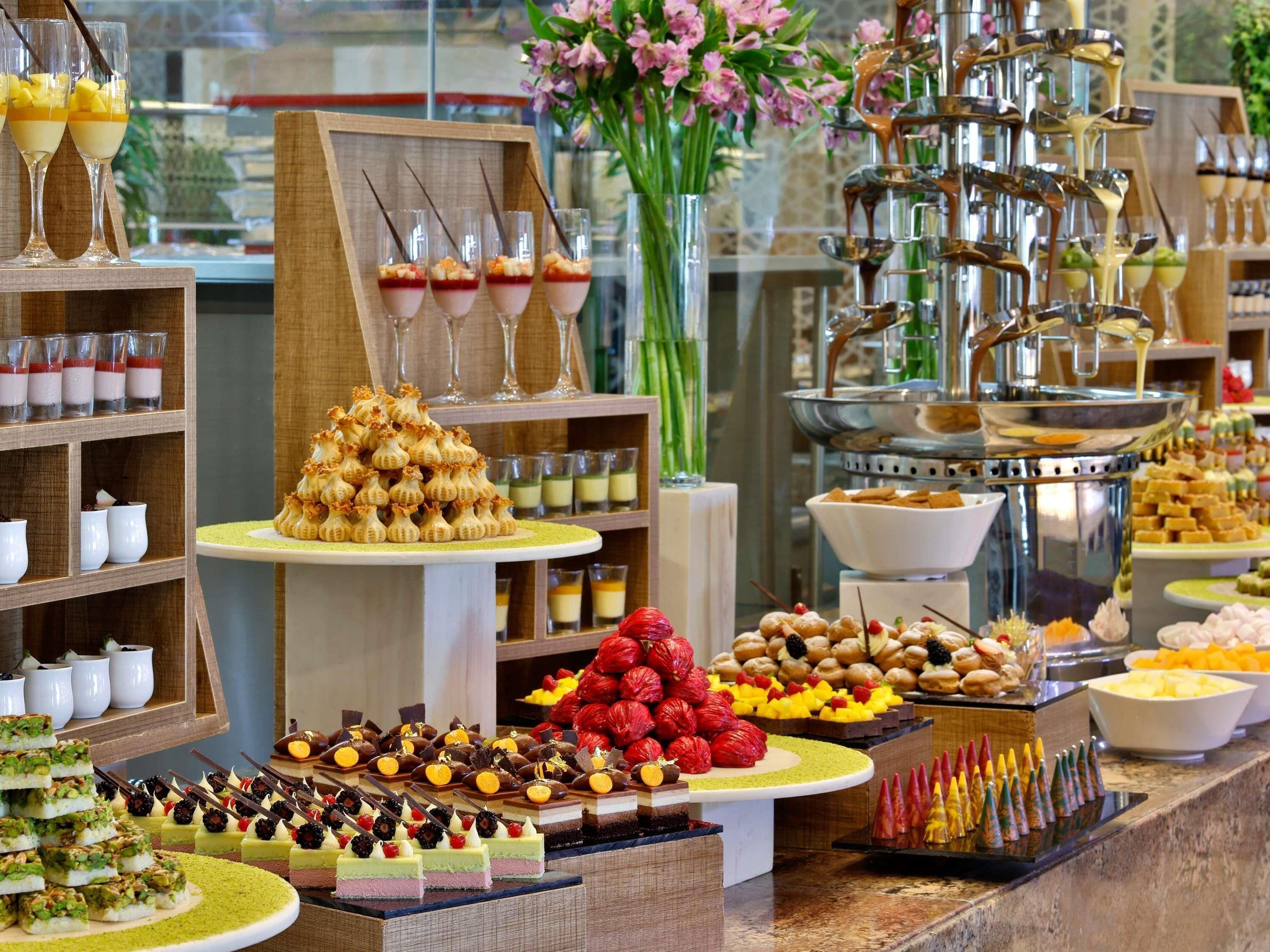A buffet with various desserts and beverages.