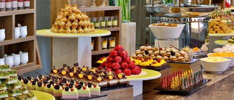 A buffet with various desserts and beverages.