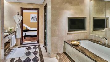 Bathroom features a large mirror, bathtub, and marble-patterned floor.