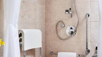 A shower with a handheld showerhead, a handheld showerhead, and a handheld showerhead.