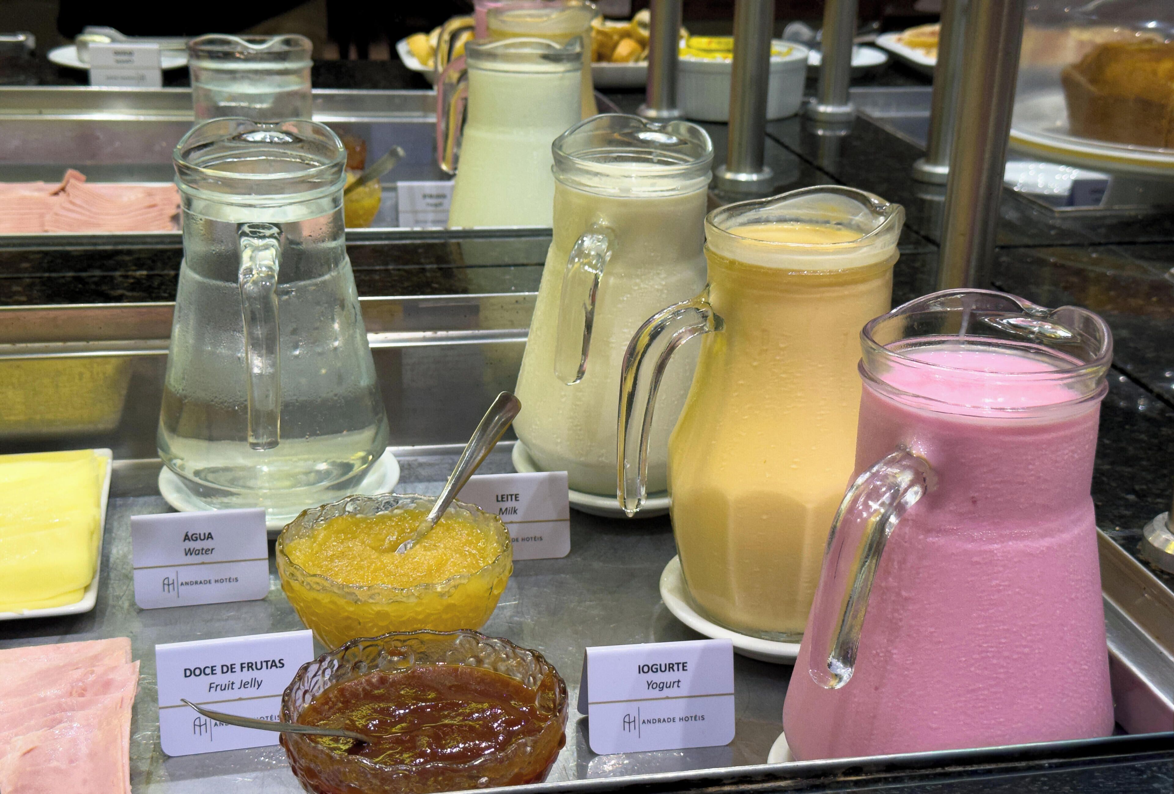 A beverage station with various drinks and labels.