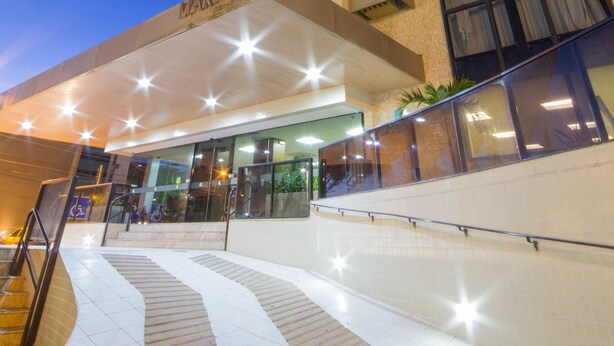 A hotel entrance with a modern design, featuring a prominent sign and a staircase leading to the lobby. - Marinas Maceió Hotel (Maceió)
