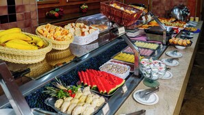 A buffet with various food items including fruits, pastries, and sandwiches. - Hotel Pan Americano (São Paulo)