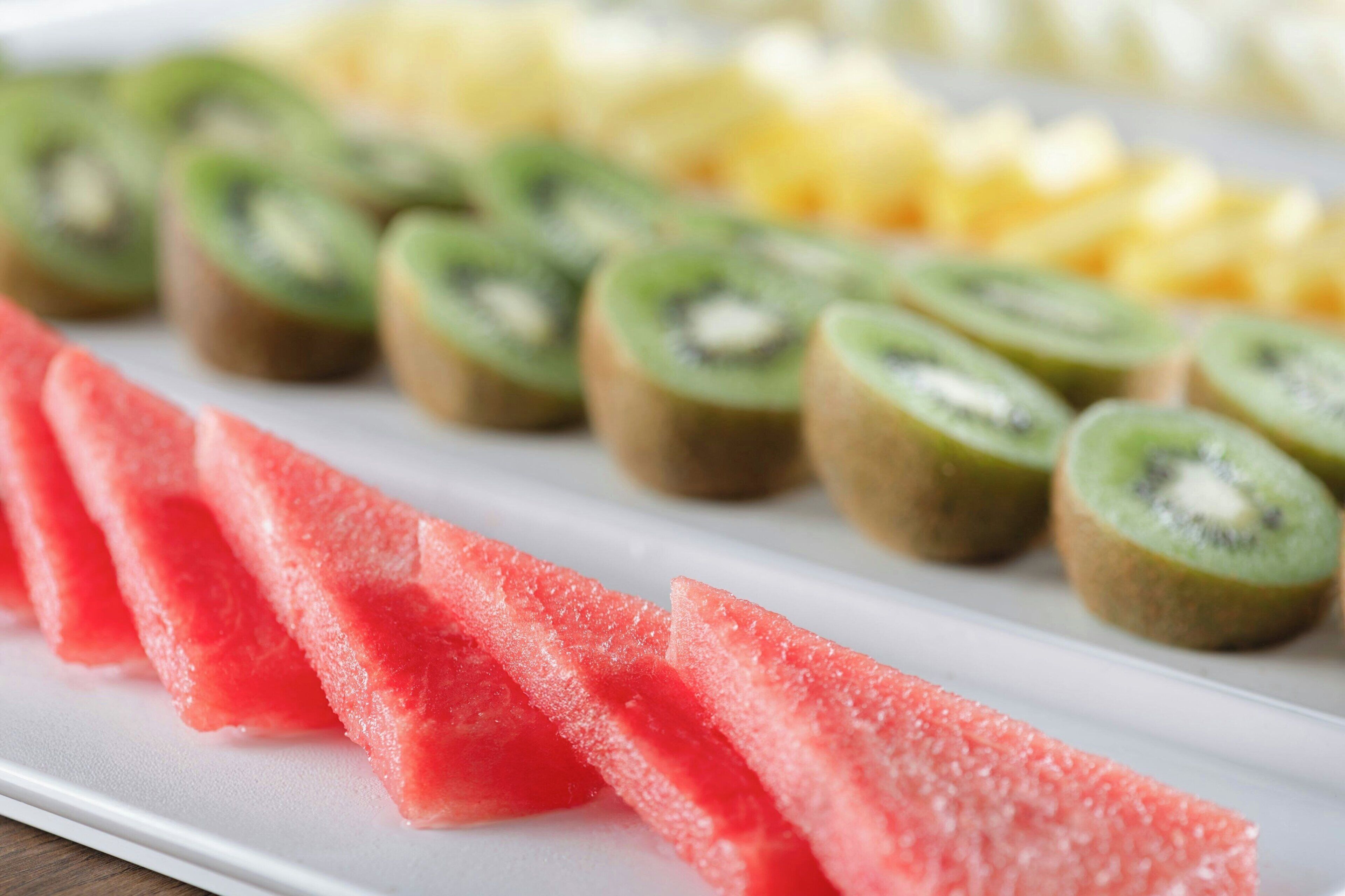 A plate with sliced watermelon and kiwi.