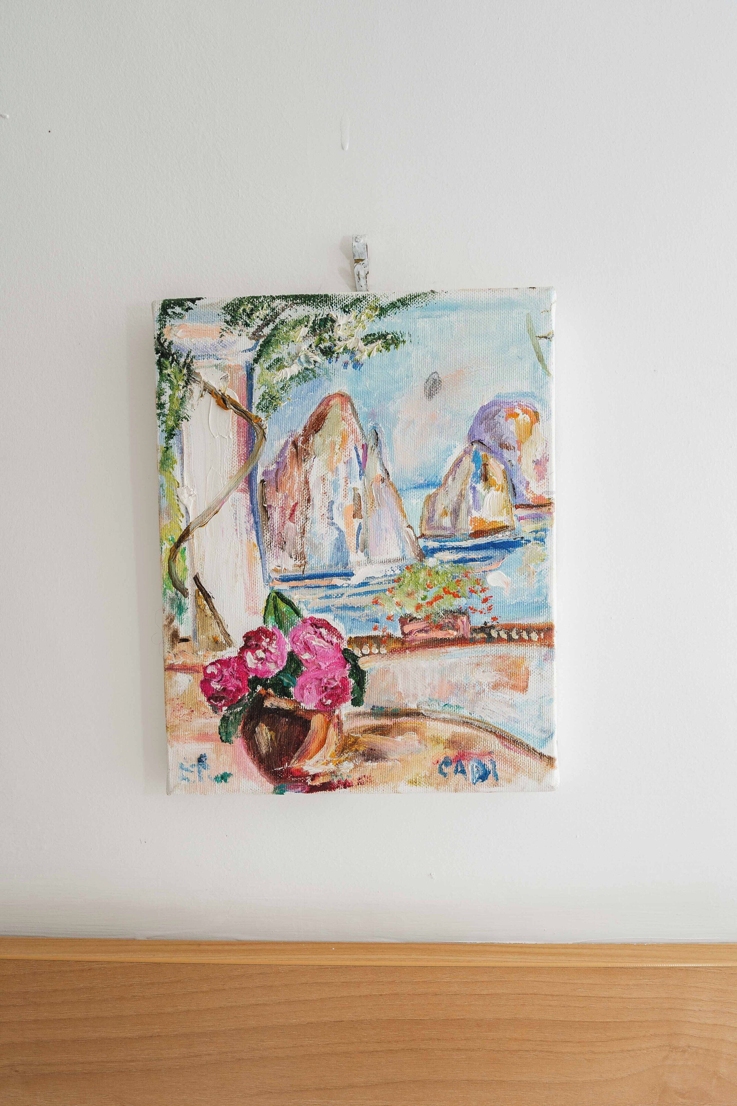 A painting of a coastal scene with mountains, boats, and flowers.