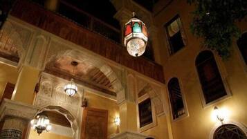 A traditional building with ornate arches and a hanging lantern.