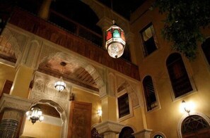 A traditional building with ornate arches and a hanging lantern.