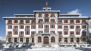 A large, historic hotel with multiple floors, a central entrance, and a snow-covered exterior.
