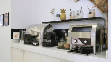 A coffee station with a coffee machine, a frosted glass coffee pot, and a menu board.