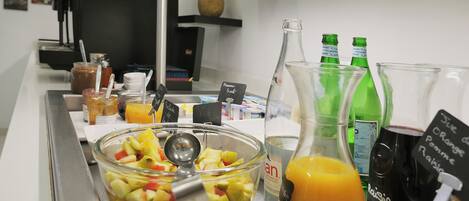 A buffet setup with a variety of food items and beverages.