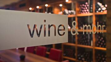 A sign with the text "wine & mohr" in a restaurant setting.