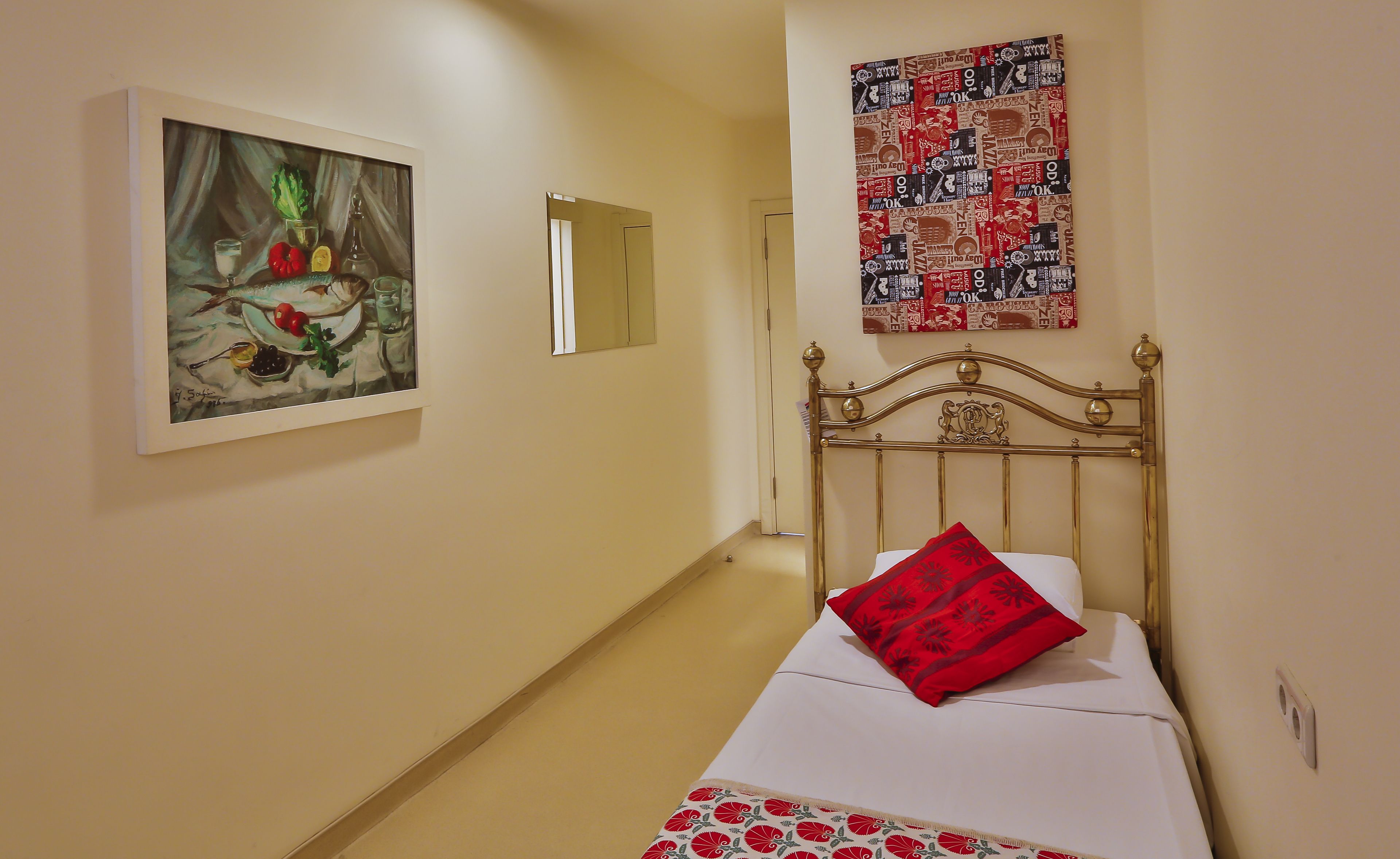 Una habitación de hotel con una cama, un cuadro en la pared y un cartel.