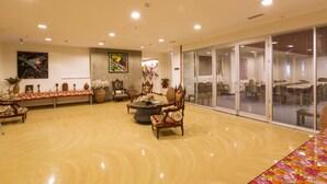 A spacious lobby with a polished floor, a central round table, and ornate chairs. - Han Hotel (Istanbul)