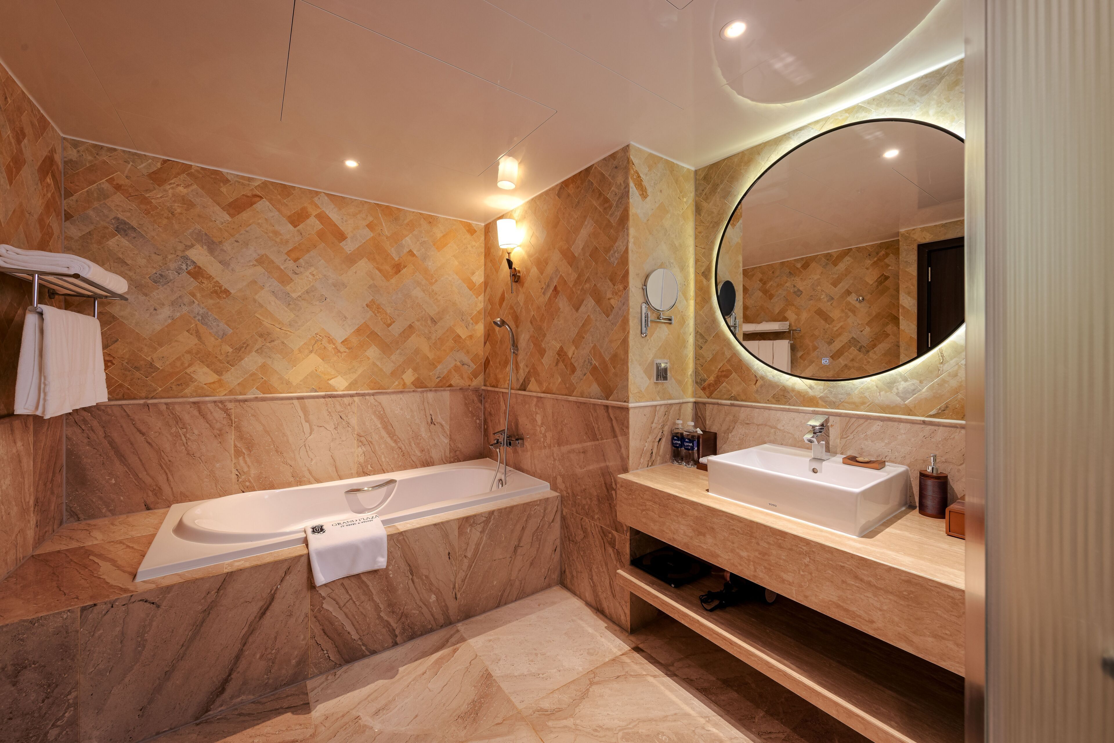 A modern bathroom with a freestanding bathtub, a vanity with a mirror, and a shower.