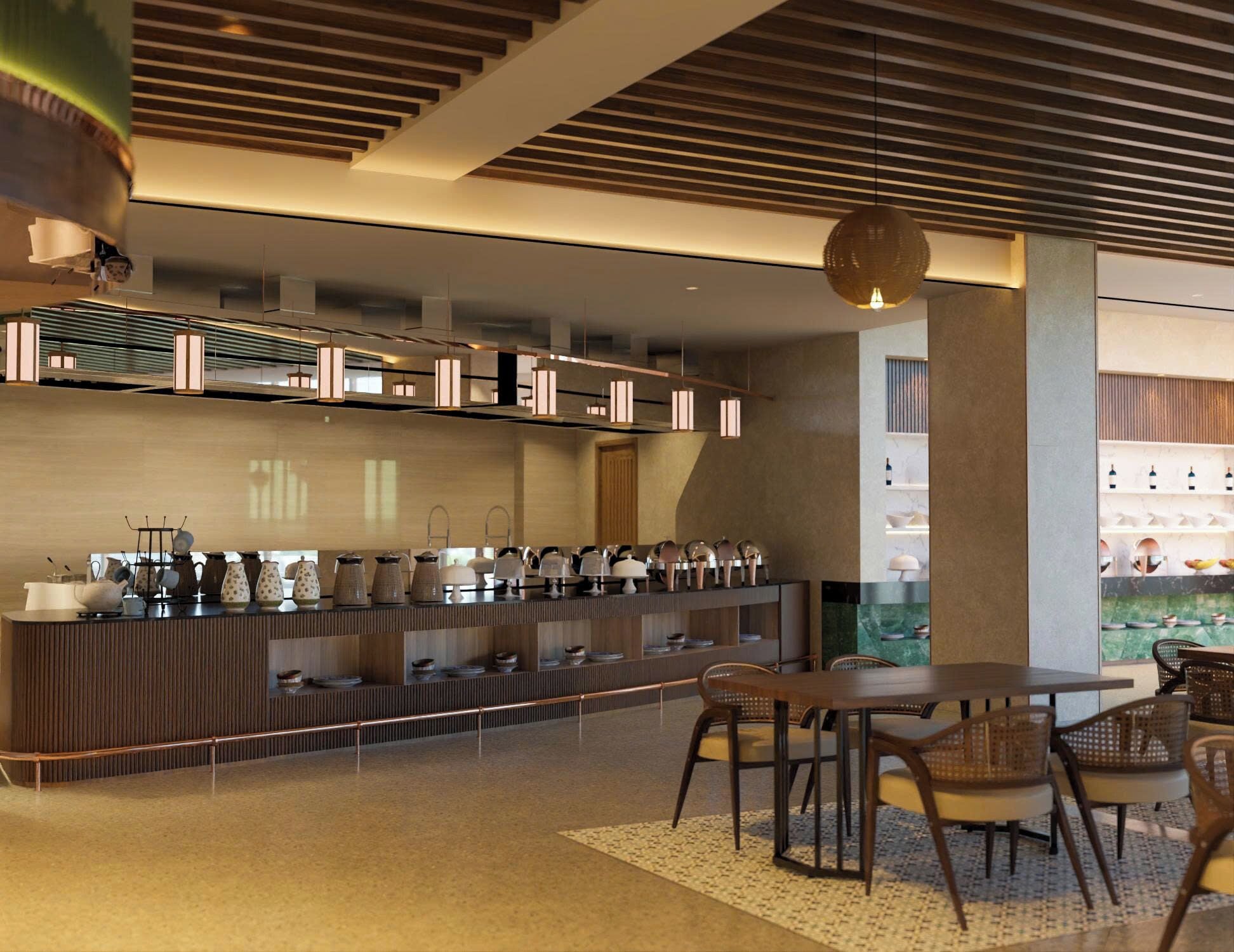 Una cocina moderna con una encimera amplia que exhibe diverso menaje, una zona de comedor con una mesa y sillas, y un ventanal grande que proporciona luz natural.