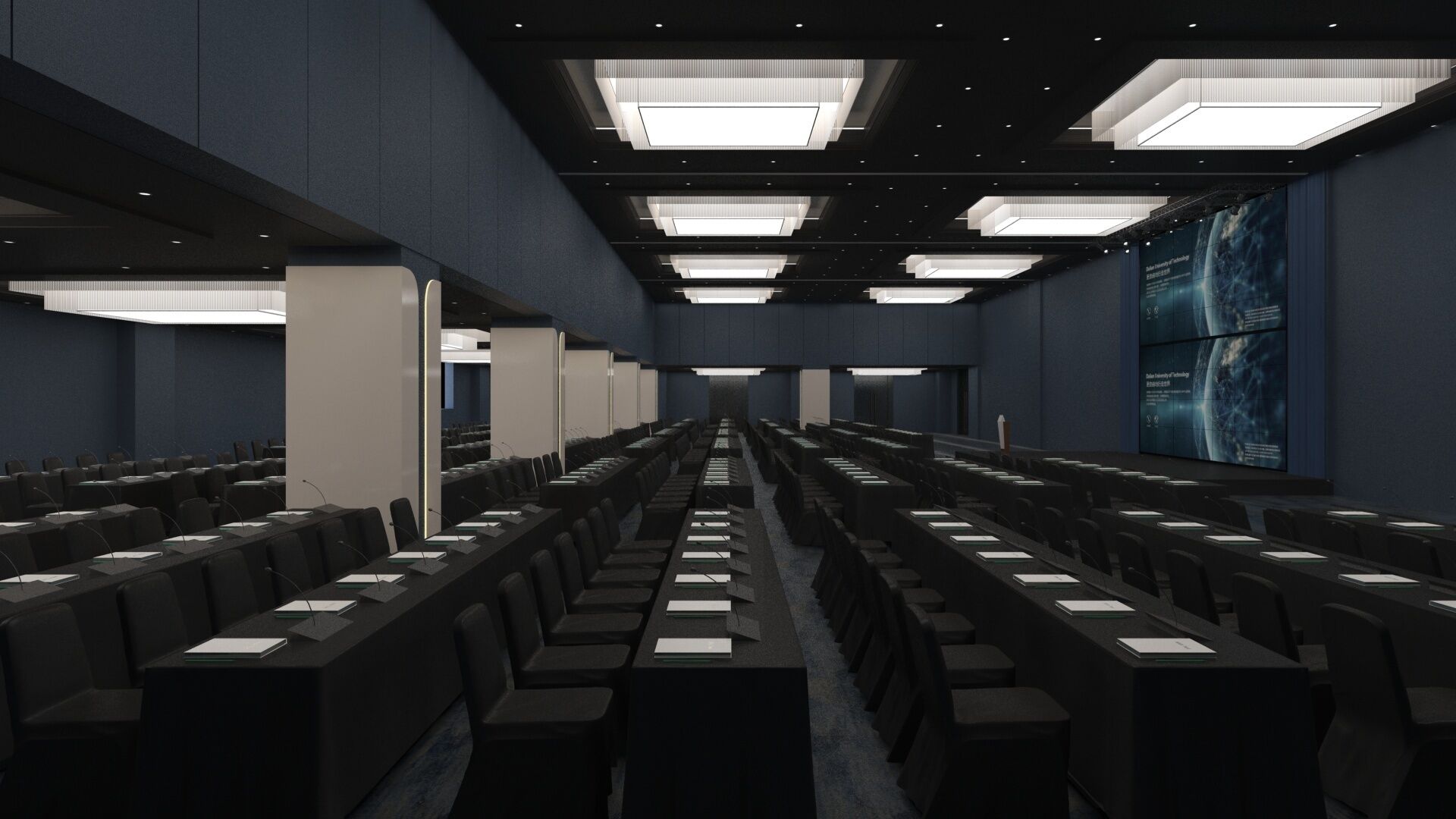 A conference room with rows of tables and chairs, large windows, and a high ceiling with recessed lighting.