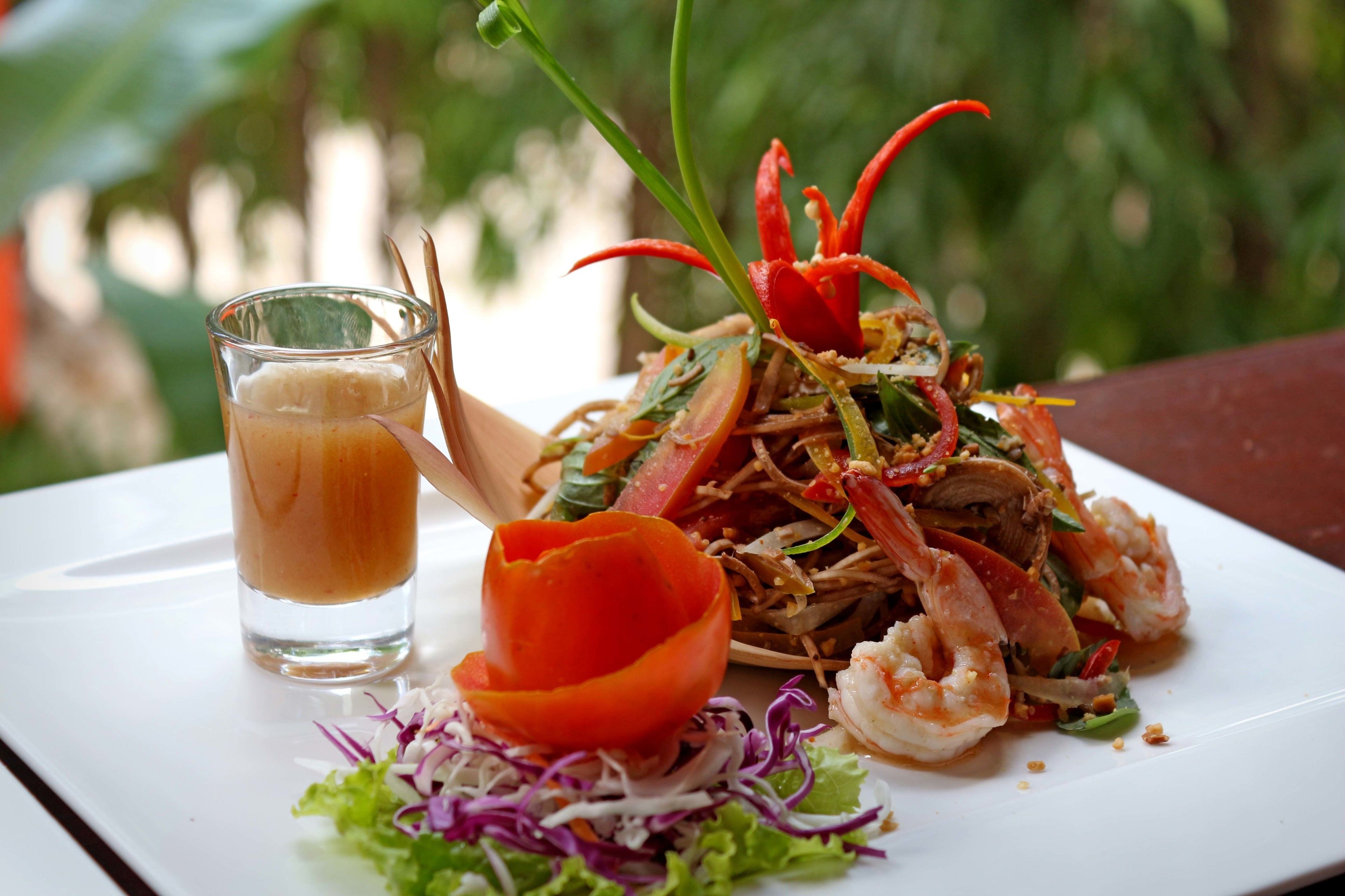 A plate of food with a glass of a light-colored beverage.
