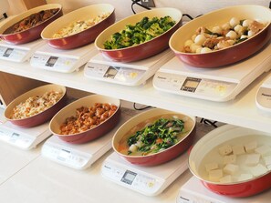 A buffet with various dishes displayed on trays, each with a digital scale underneath. - Imari Grand Hotel (Imari)