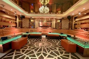 A luxurious lounge area with plush seating, a patterned floor, and ambient lighting. - Gladden Hotel (Fenggang Town) (Dongguan)
