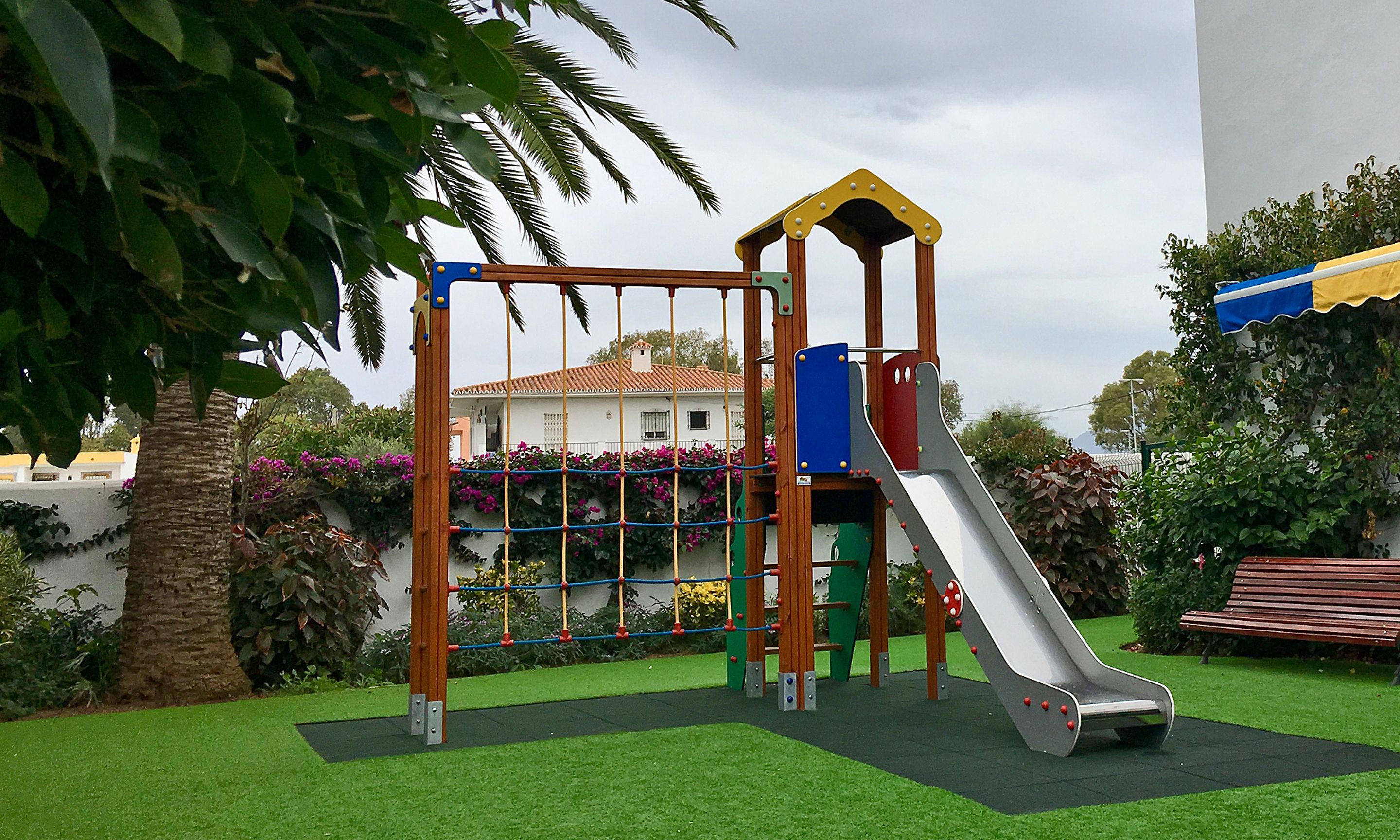 A playground with a slide and climbing structures.