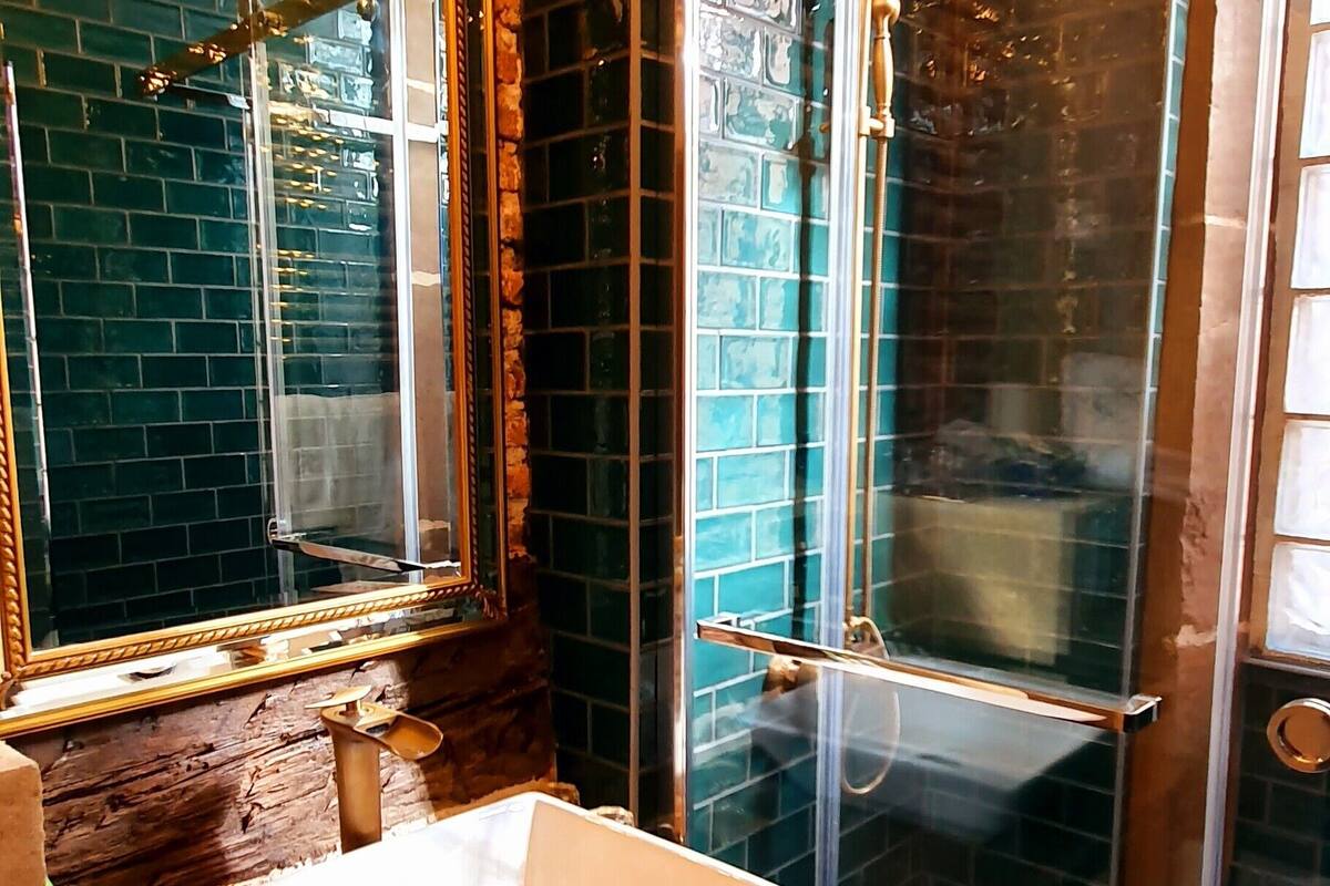 bathtub, designer toiletries, hair dryer, towels