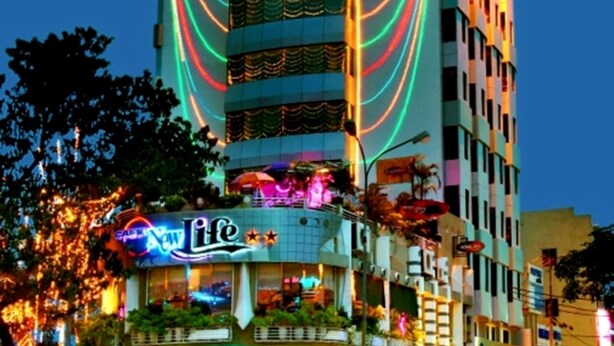 A multi-story hotel with a prominent 'PACIFIC' sign, featuring balconies and a ground-level restaurant. - Danang Pacific Hotel (Da Nang)