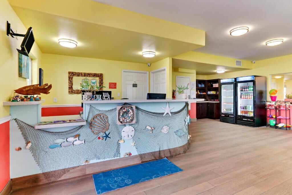 A kitchen with a central island, wooden cabinets, and a refrigerator.