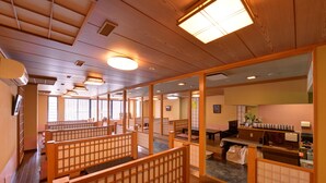 A traditional Japanese inn with tatami mat rooms, wooden sliding doors, and a reception area with a counter and seating. - Nikko Sansui (Nikko)