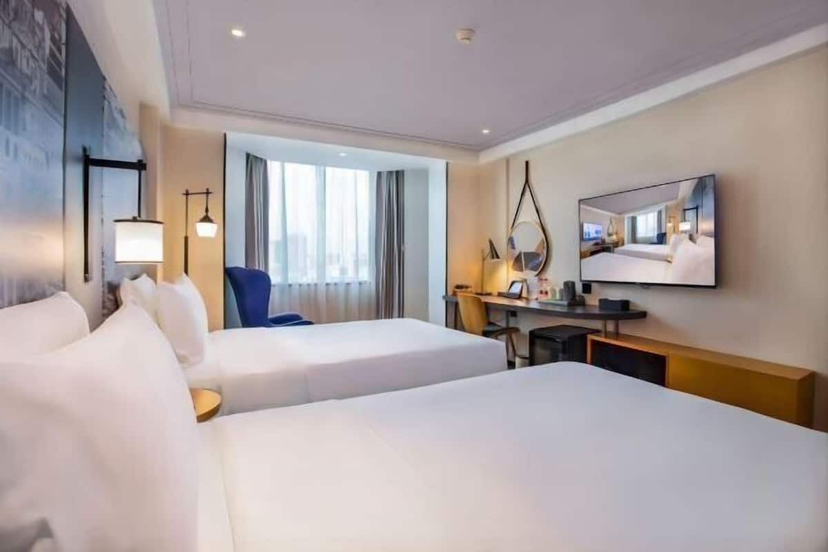 Luxe beddengoed, een minibar, een kluis op de kamer, een bureau