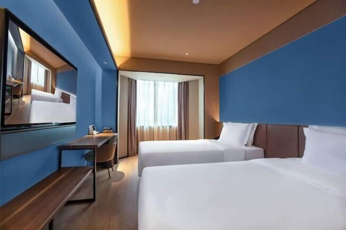 Luxe beddengoed, een minibar, een kluis op de kamer, een bureau