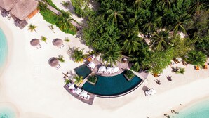 An aerial view of a resort with a pool, beach, and palm trees. - Constance Moofushi All Inclusive (Moofushi Island)