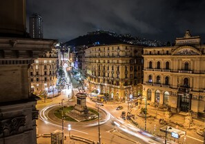 A nighttime cityscape with historic buildings, a roundabout, and a statue. - Le Orchidee (Naples)