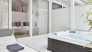 A spa area with a hot tub, a seating area with a sofa and a table, and a sliding glass door leading to a room. - Mr and Mrs White Corfu Couples Retreat Adults Only (Corfu)