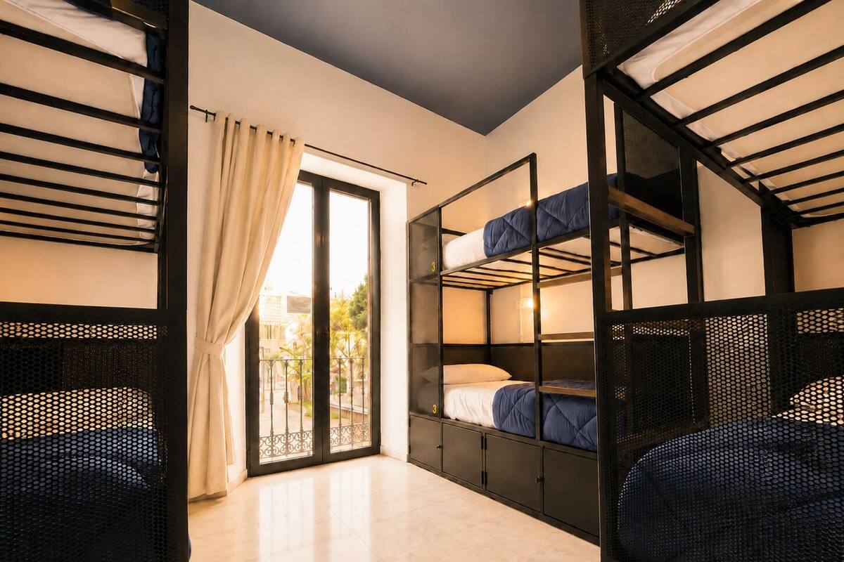 A room with bunk beds, a sliding glass door, and a tiled floor.