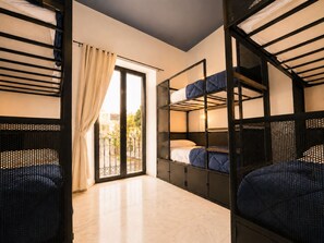 A room with bunk beds, a sliding glass door, and a tiled floor. - JOY Setas Coworking (Seville)