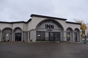 A building with a sign reading 'LACOMBE MOTOR INN LOBBY' and a visible entrance. - Lacombe Motor Inn (Lacombe)